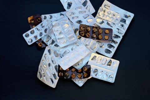 Empty packaging from under the pills on a black background Stock-Fotos