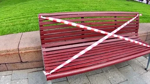An empty painted bench tied with red and white tape Stock Footage 130819660