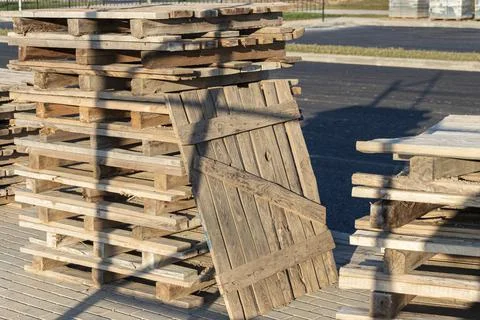 Empty pallets at a construction site. Reuse of wooden pallets in construction Photos