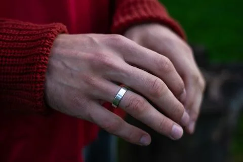 Empty palms of a man up close in a sweater. An engagement ring on her finger Stock Photos