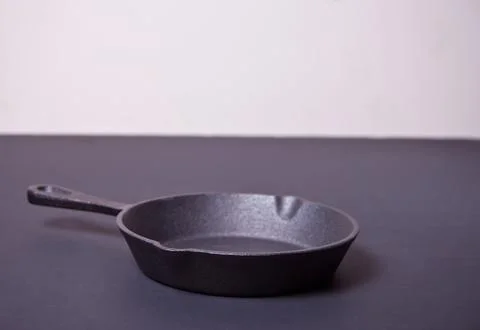 Empty pan for cooking on dark table Stock Photos