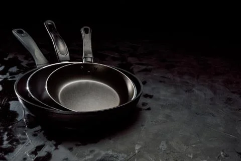 Empty pan on dark background Stock Photos