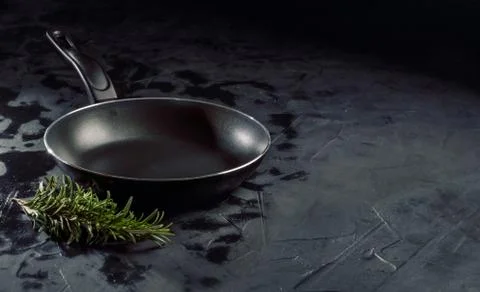 Empty pan on dark background Stock Photos