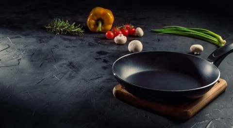 Empty pan on dark table Stock Photos