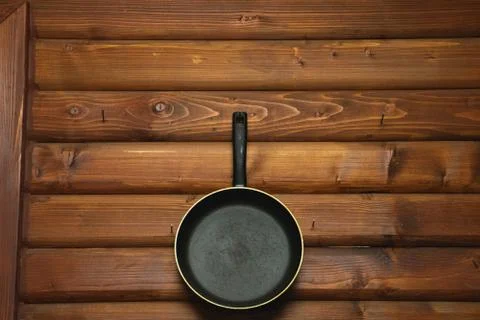 Empty Pan on the wall, wood background Stock Photos