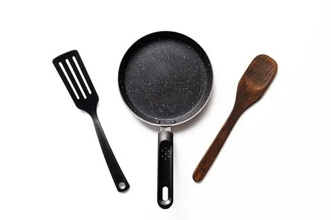 Empty pan on white background. Fried pan with spatula Stock Photos