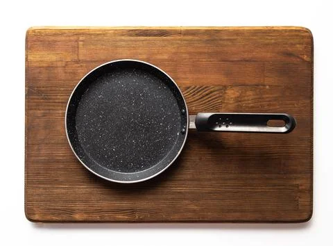 Empty pan on wood board. Empty marble coated iron pot Stock Photos