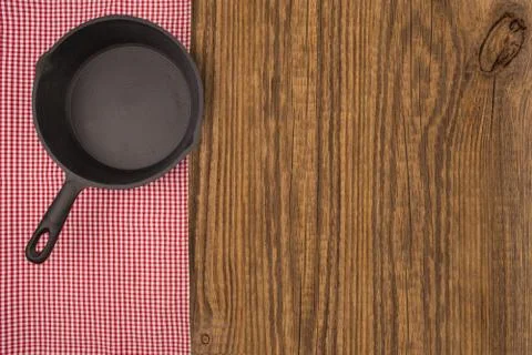 Empty pan on wooden deck table with tablecloth. Flat mock up for design. Top Stock Photos
