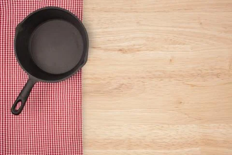 Empty pan on wooden deck table with tablecloth. Flat mock up for design. Top Stock Photos
