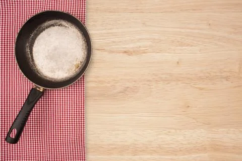 Empty pan on wooden deck table with tablecloth. Flat mock up for design. Top Stock Photos
