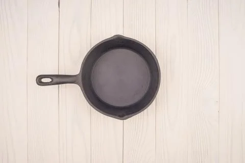 Empty pan on wooden deck table with tablecloth. Flat mock up for design. Top Stock Photos