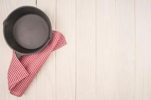 Empty pan on wooden deck table with tablecloth. Flat mock up for design. Top Stock Photos