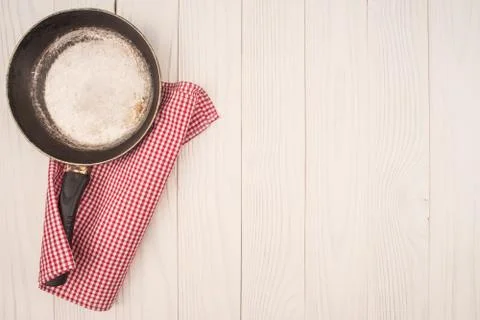 Empty pan on wooden deck table with tablecloth. Flat mock up for design. Top Stock Photos