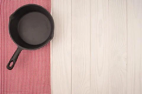 Empty pan on wooden deck table with tablecloth. Flat mock up for design. Stock Photos
