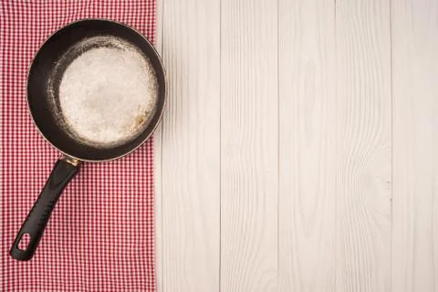 Empty pan on wooden deck table with tablecloth. Flat mock up for design. Top Stock Photos