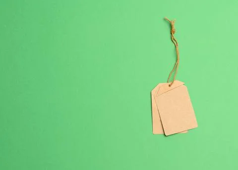 Empty paper brown rectangular price tag on a rope Stock Photos