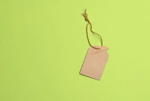 Empty paper brown rectangular price tag on a rope Stock Photos