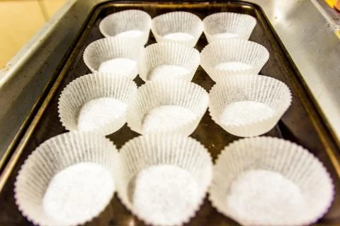 Empty paper muffin cups on baking tray Photos