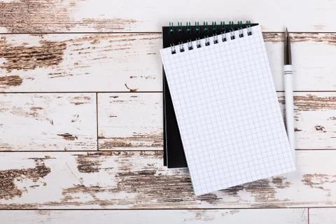 Empty paper notebook on brown wooden table background. Top view Concept of a  Stock Photos