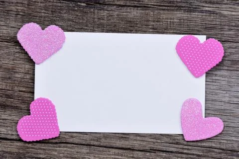Empty paper with pink hearts on rustic table Stock Photos
