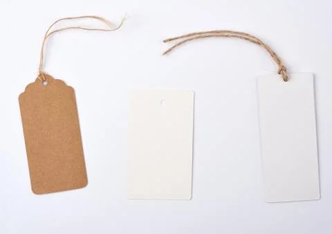 Empty paper round and rectangular brown tag on a rope 스톡 사진