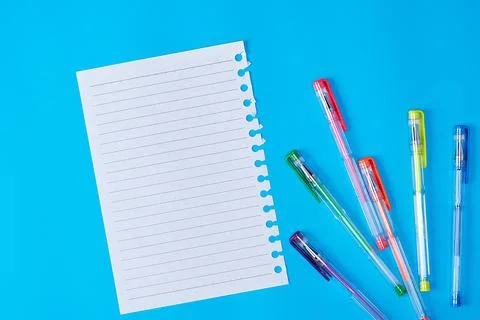 Empty paper sheet in a line and multi-colored gel pens Stock Photos