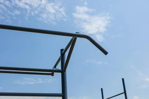 Empty parallel bars set in an outdoor gym, perfect for workout enthusiasts .. Stock Photos