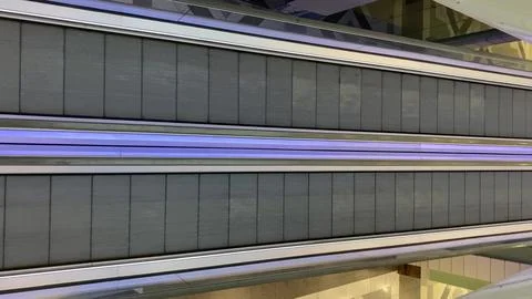 Empty parallel moving walkways with blue light accent 스톡 사진