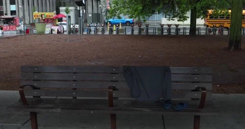 Empty park bench with abandoned shirt and sandals after the rain Stock Footage 321035537