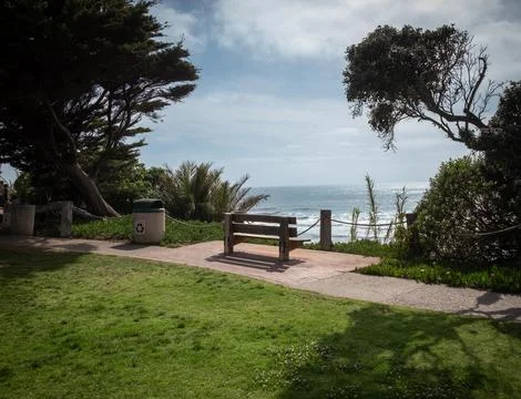 Empty Park Bench overlooking Pacific Ocean Stock Photos