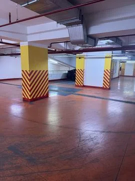 Empty parking garage with striped columns Stock Photos