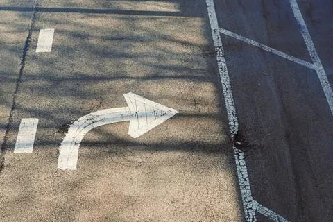 Empty parking lot with directional arrow and shadow lines 스톡 사진