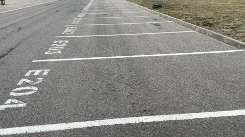 The empty parking lot features clearly marked designated parking spaces E204 and Stockbeeldmateriaal 316421590