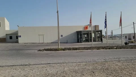 Empty parking lot, flags, late afternoon, store entrance Video stock 169524198