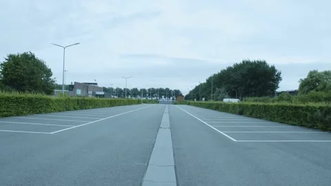 Empty Parking Lot Surrounded By Bushes And Trees Video stock 247141405