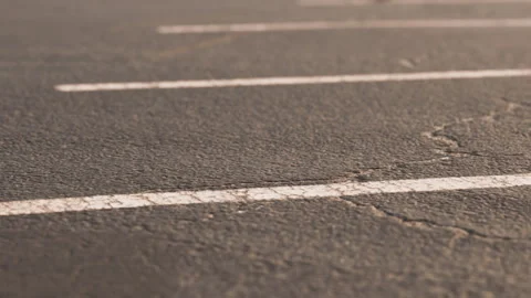 Empty parking lot with visible lines on cracked asphalt surface Stock Footage 344160527