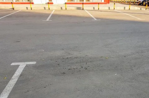 Empty parking place with white marking lines on asphalt Stock Photos