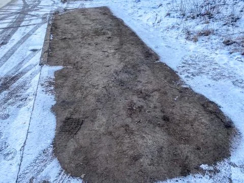 Empty parking space after a car in winter Stock Photos