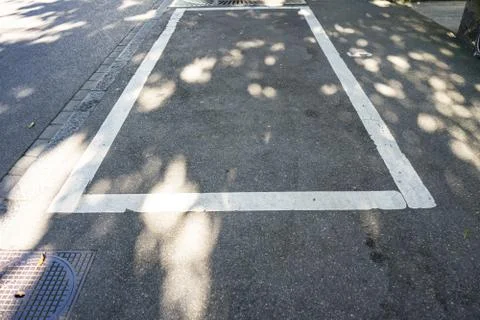 Empty parking space in the city with shadow Stock Photos