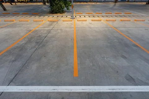 Empty parking space with orange lines on a concrete surface showing a clean.. 스톡 사진