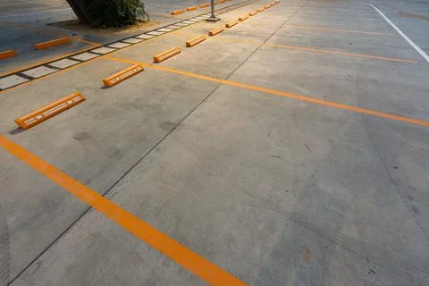 Empty parking space with orange lines on a concrete surface showing a clean.. Stock Photos