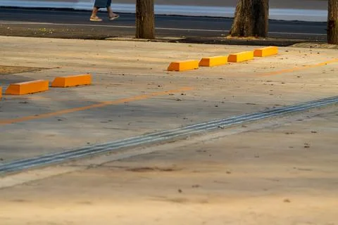 Empty parking space with orange lines on a concrete surface showing a clean.. Photos