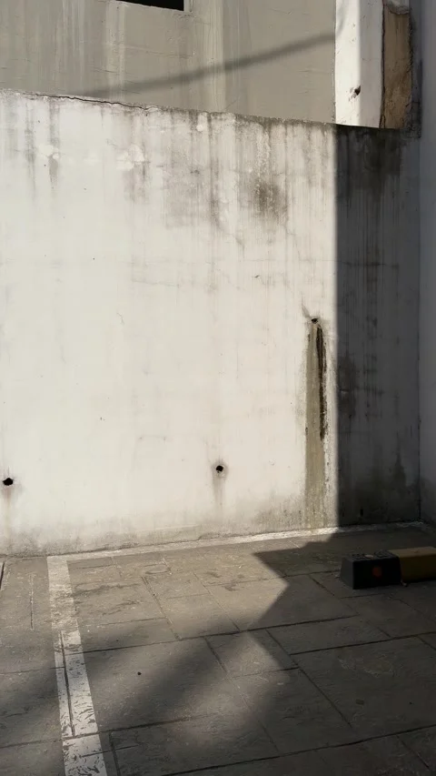 Empty Parking Space with Weathered Concrete Wall Stock Footage 337557722