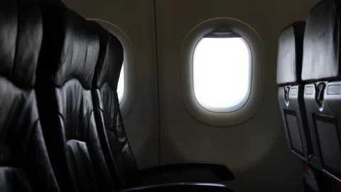 Empty passenger seat rows in plane panning shot airline business problem from Stock Footage 156292829