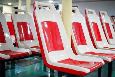 Empty passenger seats on the ferry, red and white plastic chairs Stock Photos