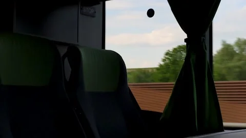 Empty passenger seats with green headrests and curtain inside a moving inte.. Stock Footage 340476871