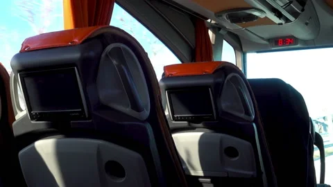Empty passenger seats with monitors in a moving bus. Stock Footage 108502147