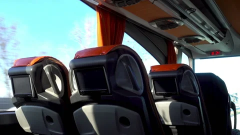 Empty passenger seats with monitors in a moving bus Stock Footage 108502167