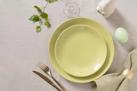 Empty pastel green Easter plate with gold cutlery Stock Photos