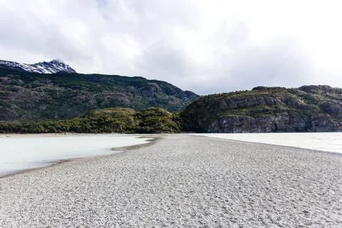 Empty path during low tide in Glacier Gray, beautiful green mountain in the b Stock Photos